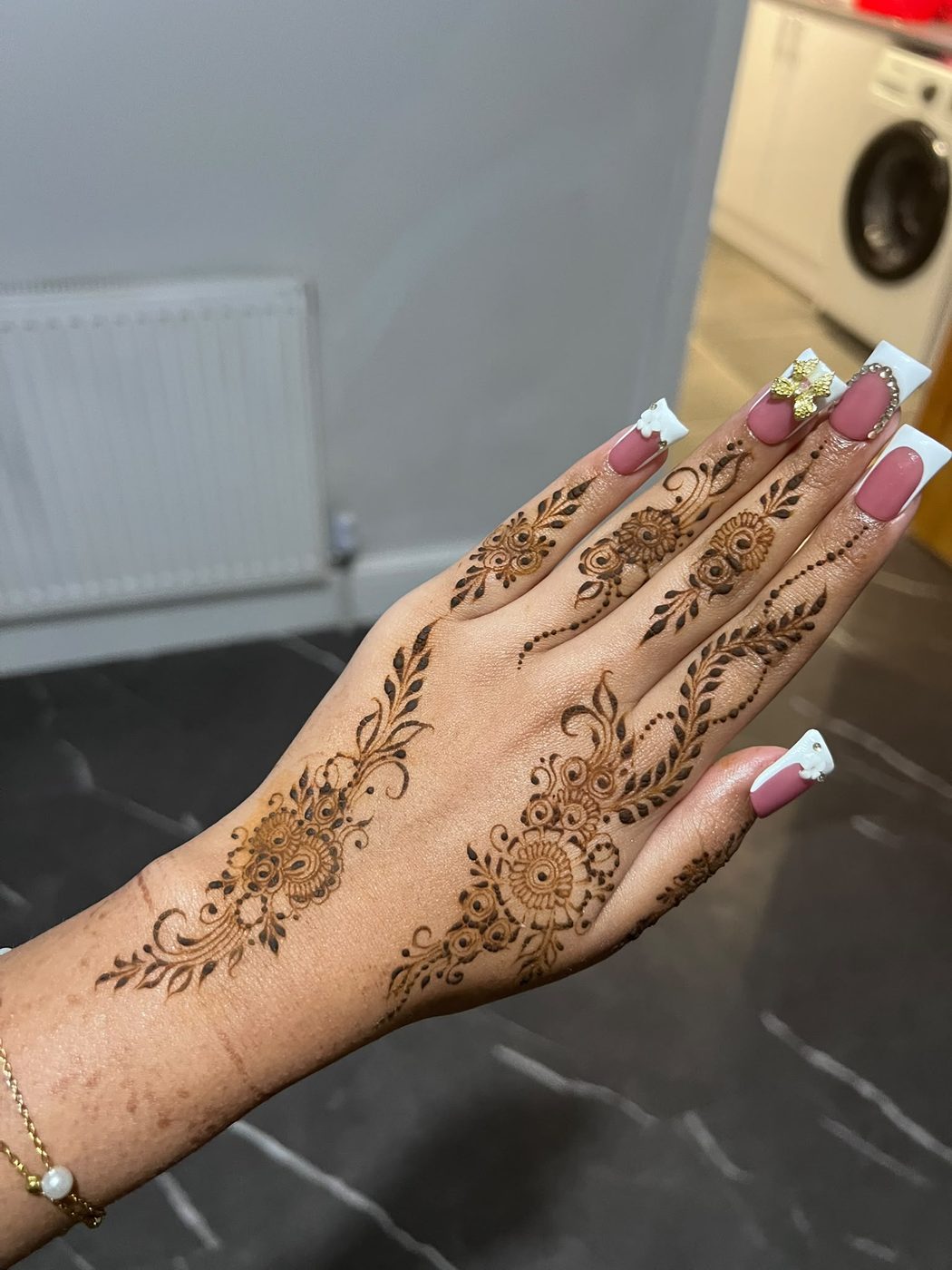 Delicate henna pattern on fingers and hand