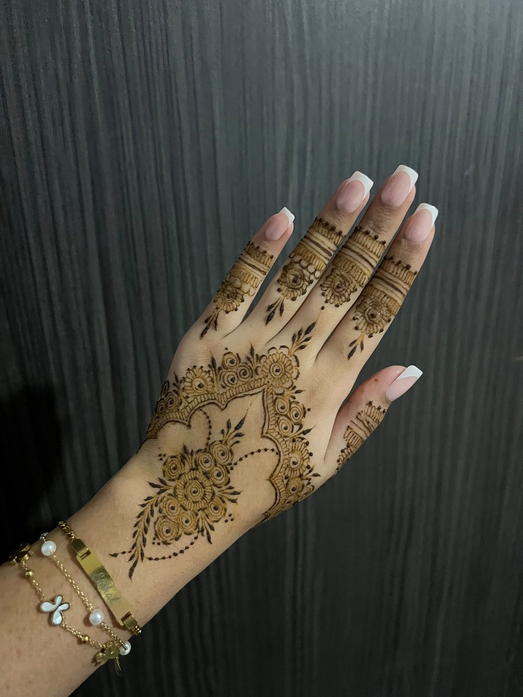 Ornate floral vine henna design on hand